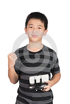 Successful happy Asian boy holding radio remote control for dron