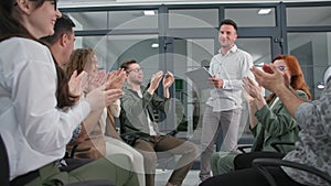 successful happy business team happily clap their hands while sitting in circle during professional training in office