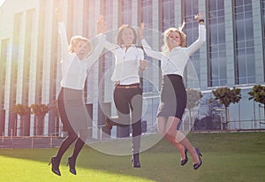 Successful and happy business woman jumping up