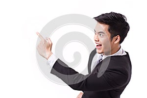 Successful, happy businessman pointing up at blank space