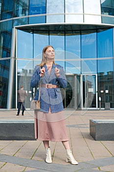 Successful happy woman on her way to work in street. Confident business woman