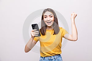 Successful happy woman holding mobile phone isolated on a white background