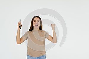 Successful happy woman holding obile phone on a white background