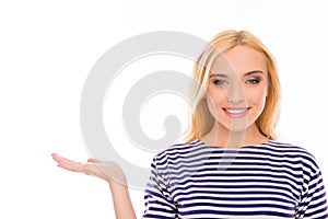 Successful happy woman in striped T-shirt demonstrating product