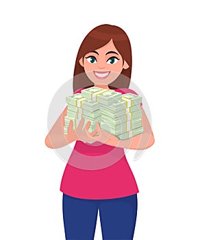 Successful happy young business woman holding cash / money / currency / banknote bundle in hands. Business and finance concept.