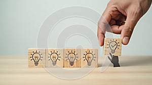 Successful Idea & Solution Selection - Hand Placing Lightbulb Checkmark Block