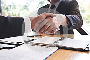 Successful job interview with boss and employee shaking hands after negotiation or interview, career and placement concept