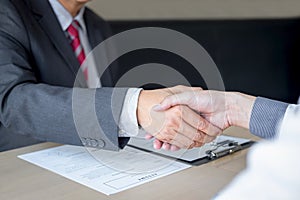 Successful job interview, Boss employer in suit and new employee shaking hands after negotiation and interview, career and