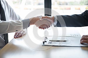 Successful job interview, Boss employer in suit and new employee shaking hands after negotiation and interview, career and photo