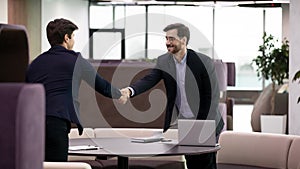 Successful job interview, business man handshaking with young candidate