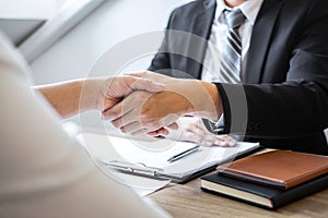 Successful job interview, Image of Boss employer committee or recruiter in suit and new employee shaking hands after good deal