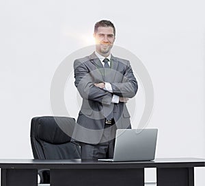 Successful leader, standing behind a Desk
