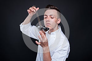 Successful male cook tasting his soup