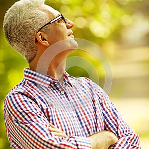 Successful man concept. Portrait of smiling happy mature man in trendy casual shirt & stylish glasses looking up and posing in the