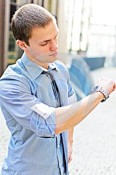 Successful man looking at his watch.