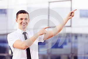 Successful man pointing at side