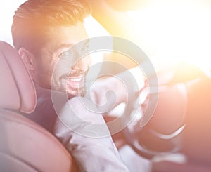 Successful man sitting behind the wheel of a prestigious car