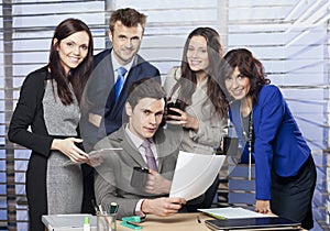 Successful manager surround by his business team