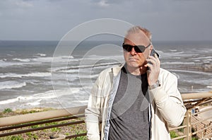 Successful matur man on the background of the sea