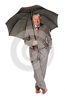 Successful mature businessman with umbrella