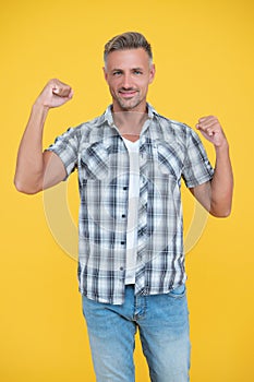 successful mature man with grizzle hair on yellow background