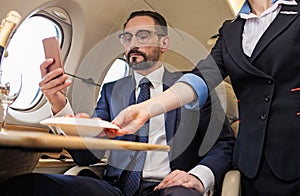 Successful middle aged man travelling by luxurious plane