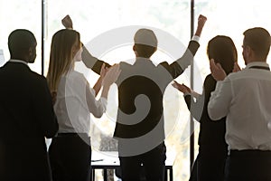 Successful motivated business team people applauding supporting proud male leader