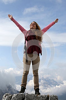 Successful mountaineer on top of a mountain photo