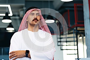 Successful muslim businessmen in traditional outfit in his office