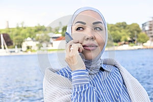 successful Muslim woman talking on the phone. Business coach