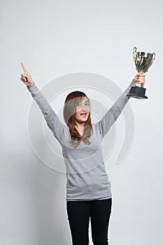Successful number one winner young asian woman holding a trophy