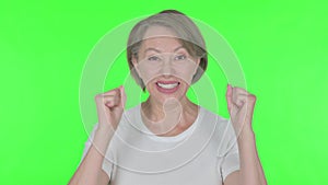 Successful Old Woman Celebrating on Green Background