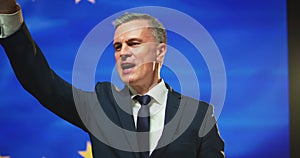 Successful politician giving promises against European flag