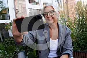 successful pretty middle-aged woman dressed stylish spends free time outdoors on a walk