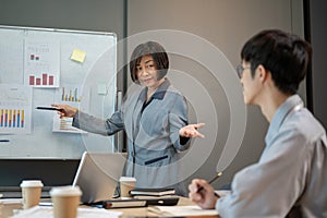 A professional senior Asian female boss is leading the meeting and briefing a new project