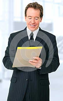 Successful Senior Businessman Writing On Notepad