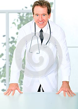 Successful Senior Doctor Standing By Table