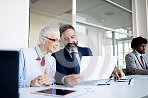 Successful team leader and business owner leading informal in-house business meeting