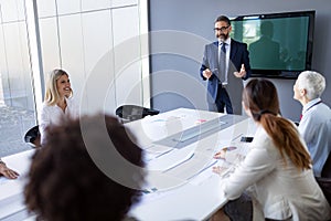 Successful team leader and business owner leading informal in-house business meeting