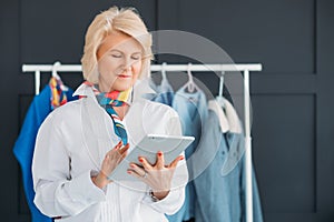 Successful seniority lady tablet fashion business
