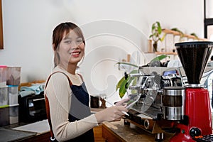 Successful small business owner young asian woman barista stand at her cafe