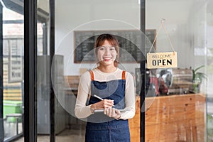 Successful small business owner young asian woman barista stand at her cafe