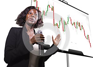 Successful stocks and forex market trading - young beautiful and happy afro American business woman and trader coaching investment