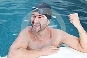 Successful swimmer smiling in the water
