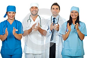 Successful team of doctors clapping together