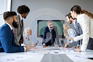 Successful team leader and business owner leading informal in-house business meeting