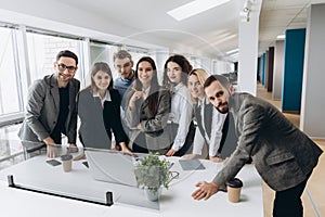 Successful team at work. Group of young business people working and communicating together in creative office photo