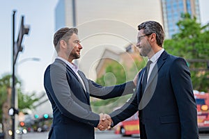 Successful teamwork. Business people shaking hands. Handshake between two business men. Two businessmen shaking hands on