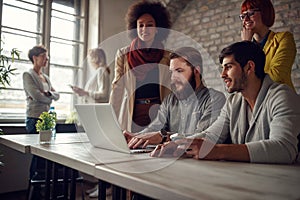 Successful teamwork- young web designers working