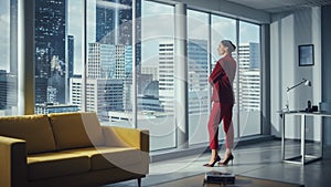 Successful Thoughtful Businesswoman Wearing Perfect Red Suit Standing in Office Looking out of